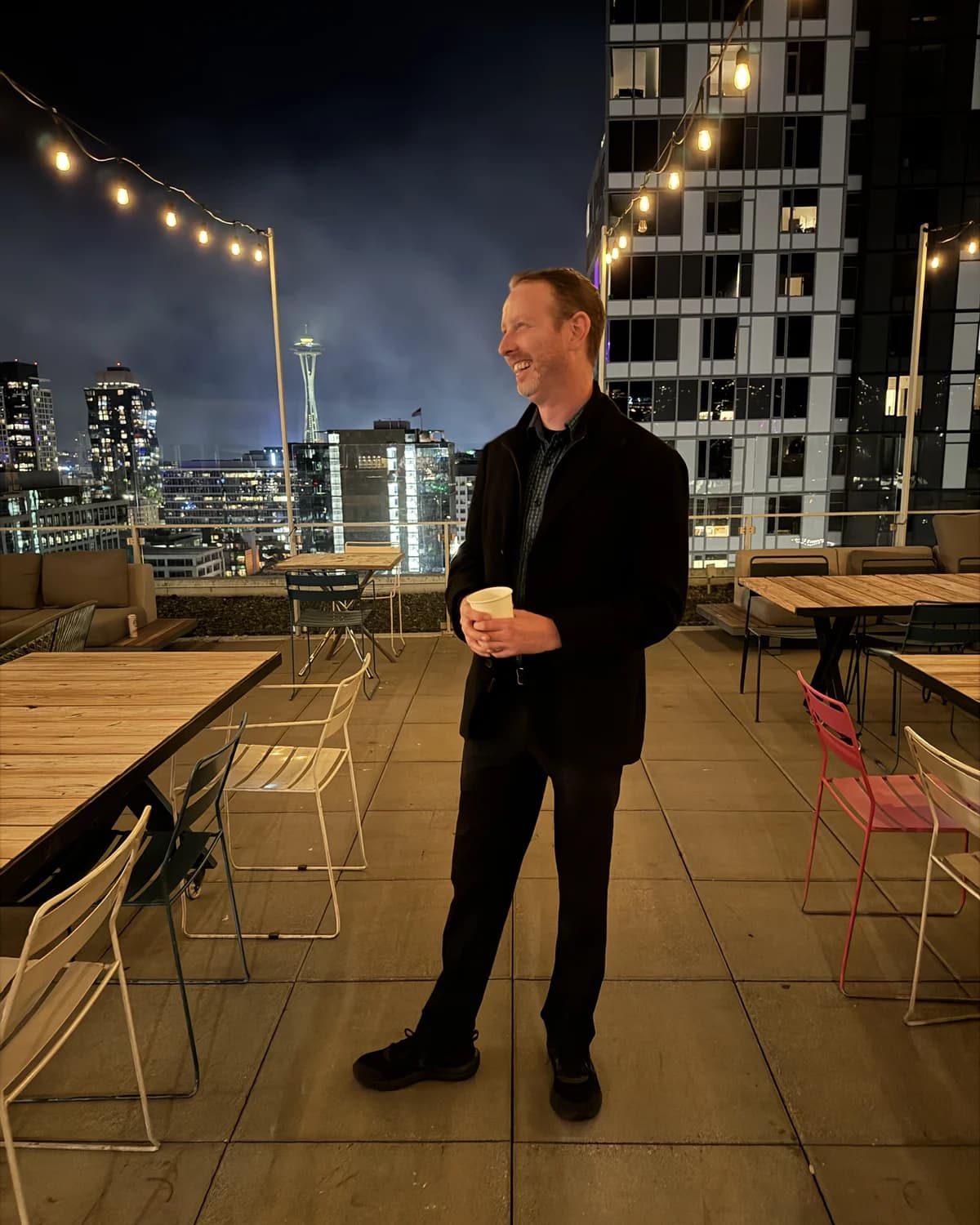 Kyle, founder of AI Motion Systems, on a Seattle rooftop at night